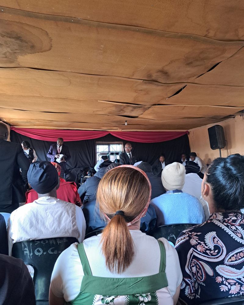 Congregation gathered for a church outreach service in a village hall