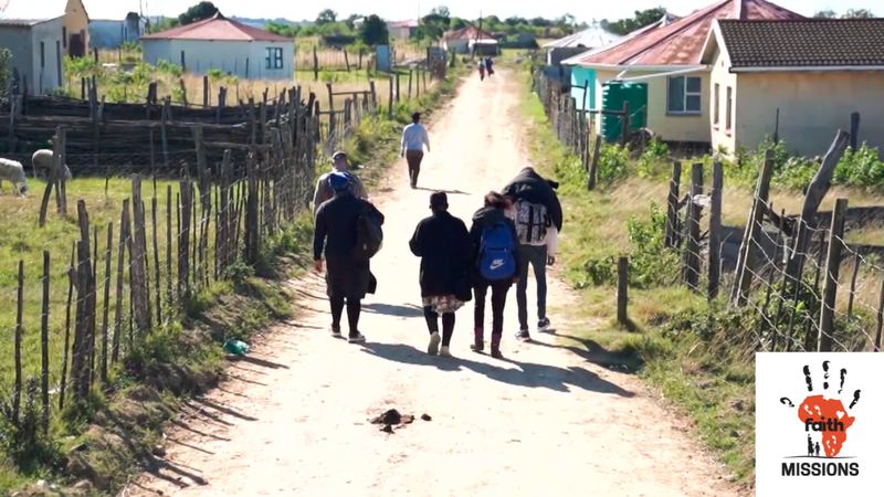 Mission team walking a village road in Nyara